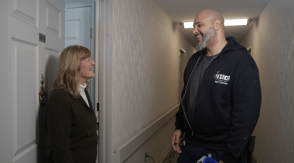 Pesticon pest control technician speaking with a homeowner during a professional rodent control service visit